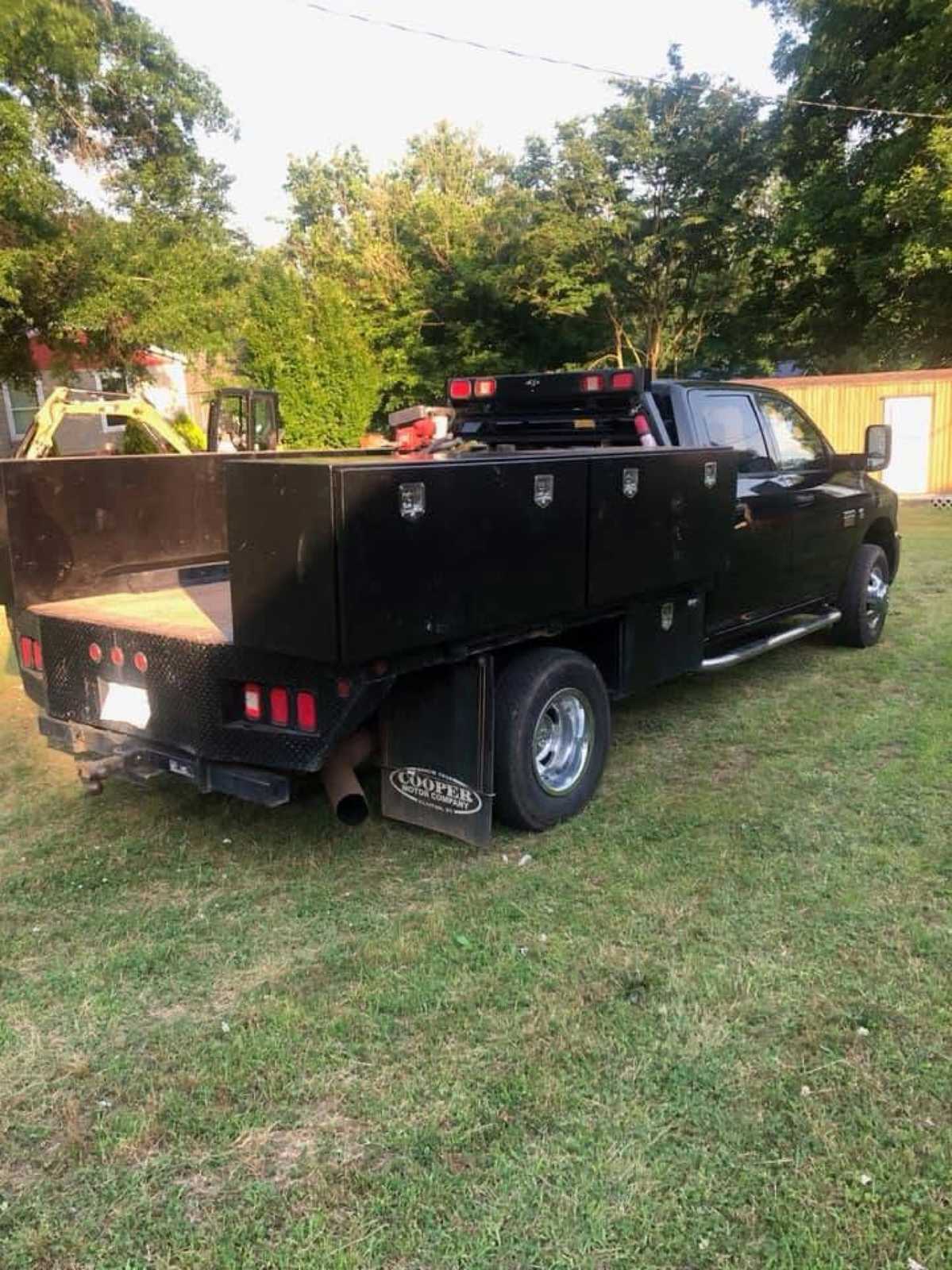 Black custom utility service truck bed with steel toolbox compartments, completed for a customer